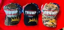 Load image into Gallery viewer, Hats - Signature “Keep America Great 2024”- American Flag Pattern Black ( 3 colours- Available @ TrumpGirl.com