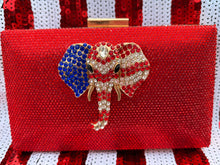 Load image into Gallery viewer, Stunning Red Crystal Clutch Handbag. Embellished with a beautiful red, white, &amp; blue crystal elephant. Chain included for shoulder wear.